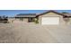 Single-story home with a gravel front yard, solar panels, brick accents and a two car garage at 3632 W Kelton Ln, Phoenix, AZ 85053