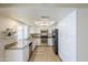 Bright kitchen with stainless steel appliances, granite countertops, and white cabinetry at 3632 W Kelton Ln, Phoenix, AZ 85053