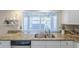Bright kitchen features granite countertops, stainless steel appliances, and a garden view through the window at 3632 W Kelton Ln, Phoenix, AZ 85053