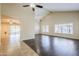 Bright living room featuring dark wood floors, large windows and a vaulted ceiling with ceiling fans at 3632 W Kelton Ln, Phoenix, AZ 85053