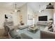 Virtually staged living room showing open plan, vaulted ceilings, and dark wood floors at 3632 W Kelton Ln, Phoenix, AZ 85053