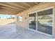 Covered patio with sliding glass doors overlooking a refreshing swimming pool at 3632 W Kelton Ln, Phoenix, AZ 85053