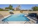 Backyard with fenced pool, hot tub, blue patio umbrella, and block wall at 3632 W Kelton Ln, Phoenix, AZ 85053