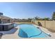 A fenced backyard features a large pool, hot tub, and patio umbrella at 3632 W Kelton Ln, Phoenix, AZ 85053