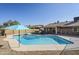 The backyard has a fenced pool, hot tub, patio umbrella, and gravel at 3632 W Kelton Ln, Phoenix, AZ 85053