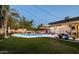 Inviting backyard with a pool, lounge area, lush lawn, and mature landscaping at 3640 E Fairmount Ave, Phoenix, AZ 85018