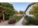 Scenic backyard with lush greenery, a pool, patio seating, and charming landscaping at 3640 E Fairmount Ave, Phoenix, AZ 85018