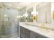 Modern bathroom with a dual vanity, marble countertops, and glass-enclosed shower at 3640 E Fairmount Ave, Phoenix, AZ 85018