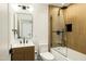 Modern bathroom featuring a shower-over-tub, wood paneling, and sleek fixtures at 3640 E Fairmount Ave, Phoenix, AZ 85018