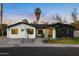 Charming single-story home featuring white and black accent walls, landscaped yard, and inviting front entrance at 3640 E Fairmount Ave, Phoenix, AZ 85018