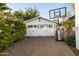Detached garage with a basketball hoop surrounded by mature landscaping at 3640 E Fairmount Ave, Phoenix, AZ 85018