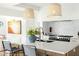 Bright kitchen showcasing a marble countertop island, stainless steel appliances, and stylish pendant lighting at 3640 E Fairmount Ave, Phoenix, AZ 85018