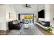 Bright living room with a leather sofa, modern fireplace, and sliding doors to the backyard at 3640 E Fairmount Ave, Phoenix, AZ 85018
