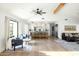 Airy living room featuring stylish furnishings, wood floors, and views of the modern kitchen and outdoors at 3640 E Fairmount Ave, Phoenix, AZ 85018