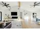 Spacious living room with hardwood floors, beamed ceiling, modern fireplace, and a view to the outdoors at 3640 E Fairmount Ave, Phoenix, AZ 85018