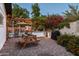 Outdoor living area with built-in barbecue, picnic table, and lush landscaping at 3640 E Fairmount Ave, Phoenix, AZ 85018