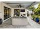 Relaxing covered patio with comfortable seating, ceiling fan, and outdoor television at 3640 E Fairmount Ave, Phoenix, AZ 85018