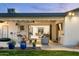 Outdoor living space with comfortable seating, and view into the home through glass doors at 3640 E Fairmount Ave, Phoenix, AZ 85018