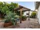 Backyard pergola with ambient lighting surrounded by raised garden beds at 3640 E Fairmount Ave, Phoenix, AZ 85018