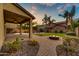 Inviting backyard featuring a cozy patio area, fire pit, and lush desert landscaping at 4064 E Morrison Ranch Pkwy, Gilbert, AZ 85296