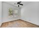 Bright bedroom with wood floors, ceiling fan, and a window providing natural light at 4064 E Morrison Ranch Pkwy, Gilbert, AZ 85296