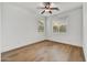 Spacious bedroom with wood flooring, ceiling fan, and natural light from two windows at 4064 E Morrison Ranch Pkwy, Gilbert, AZ 85296