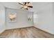 Bright bedroom with wood floors, ceiling fan, and natural light from two windows at 4064 E Morrison Ranch Pkwy, Gilbert, AZ 85296