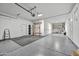 Spacious garage featuring epoxy flooring, storage shelves, and workout equipment at 4064 E Morrison Ranch Pkwy, Gilbert, AZ 85296