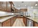 Gourmet kitchen featuring granite countertops and custom wood cabinetry at 4064 E Morrison Ranch Pkwy, Gilbert, AZ 85296