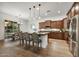 Modern kitchen featuring stainless steel appliances, an island with seating, and sleek countertops at 4064 E Morrison Ranch Pkwy, Gilbert, AZ 85296