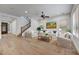 Bright living room features hardwood floors, neutral decor, and a staircase leading to the second floor at 4064 E Morrison Ranch Pkwy, Gilbert, AZ 85296