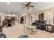 Spacious living room with a ceiling fan and open access to dining and kitchen areas, filled with natural light at 41762 W Little Ct, Maricopa, AZ 85138