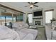 Bright living room features stone fireplace, ceiling fan, and sliding glass doors to outdoor patio at 4182 N Potomac Dr, Florence, AZ 85132