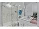 Modern bathroom with a glass shower enclosure, white vanity, and a decorative mirror at 4417 S 111Th Dr, Tolleson, AZ 85353