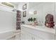 Bathroom with a shower-tub combo, vanity with mirror, and stylish decor at 4417 S 111Th Dr, Tolleson, AZ 85353