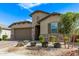 Lovely single-story home with a two-car garage, stone accents, and neatly landscaped front yard at 4417 S 111Th Dr, Tolleson, AZ 85353