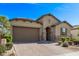 Single-story home with a two-car garage, a brick-paved driveway, and a well-maintained front yard at 4417 S 111Th Dr, Tolleson, AZ 85353