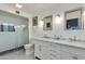 Elegant bathroom with a double vanity, marble countertop, and modern glass-enclosed shower at 5150 N 20Th St # 111, Phoenix, AZ 85016