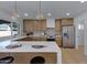 Bright kitchen featuring an island with seating, stainless steel appliances, and modern pendant lighting at 5242 S Clark Dr, Tempe, AZ 85283