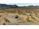 Aerial view of property with desert landscaping, gravel driveway, fenced perimeter and mountain backdrop at 53573 W Fresno Rd, Maricopa, AZ 85139