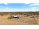 Aerial view of a fenced home with a covered patio amid desert terrain at 53573 W Fresno Rd, Maricopa, AZ 85139