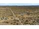 Wide aerial shot of desert landscape with multiple properties and dirt roads at 53573 W Fresno Rd, Maricopa, AZ 85139