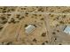 Aerial view of a single-story desert home with a fenced yard and a gravel driveway at 53573 W Fresno Rd, Maricopa, AZ 85139