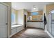 A spacious bathroom with a soaking tub, walk-in shower, and dual sink vanity with storage at 53573 W Fresno Rd, Maricopa, AZ 85139