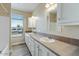 Bright bathroom with double sinks, ample cabinet space, and modern fixtures at 53573 W Fresno Rd, Maricopa, AZ 85139