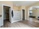Bathroom featuring walk-in shower with glass door, wood floors, and direct access to the bedroom at 53573 W Fresno Rd, Maricopa, AZ 85139