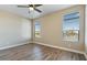 Spacious bedroom with wood-look floors, bright windows, and natural light at 53573 W Fresno Rd, Maricopa, AZ 85139