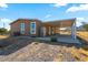 Single-story home with neutral siding showing covered parking, stainless steel fridge, and desert landscaping at 53573 W Fresno Rd, Maricopa, AZ 85139