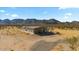 Single-story home with desert landscaping and mountain views in the background at 53573 W Fresno Rd, Maricopa, AZ 85139