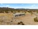 Aerial view of a home surrounded by desert landscape and mountain views at 53573 W Fresno Rd, Maricopa, AZ 85139